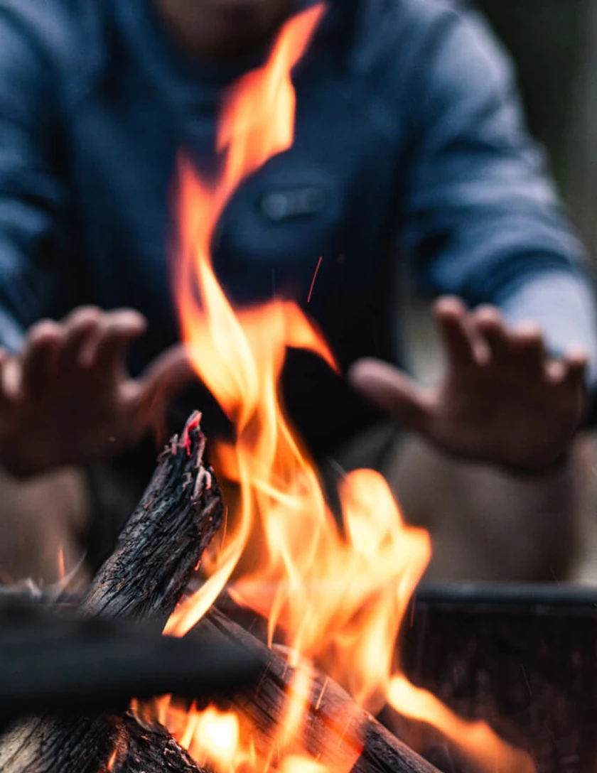 CamoLighter dual-arc plasma lighter igniting tinder outdoors in wet weather